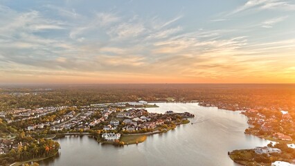 Aerial view of large mansion houses with swimming pool,  in affluent neighborhood  by Woodlands lake, Houston, Texas, expensive suburban homes surrounding by lush green trees at sunset, USA 