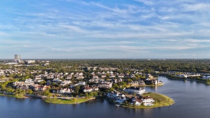 Aerial view of large mansion houses with swimming pool,  in affluent neighborhood  by Woodlands lake, Houston, Texas, expensive suburban homes surrounding by lush green trees, USA
