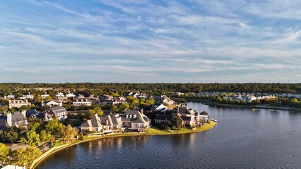 Aerial view of large mansion houses with swimming pool,  in affluent neighborhood  by Woodlands lake, Houston, Texas, expensive suburban homes surrounding by lush green trees, USA