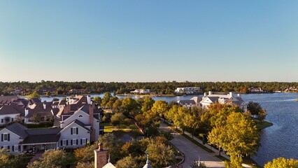 Aerial view of large mansion houses with swimming pool,  in affluent neighborhood  by Woodlands lake, Houston, Texas, expensive suburban homes surrounding by lush green trees, USA