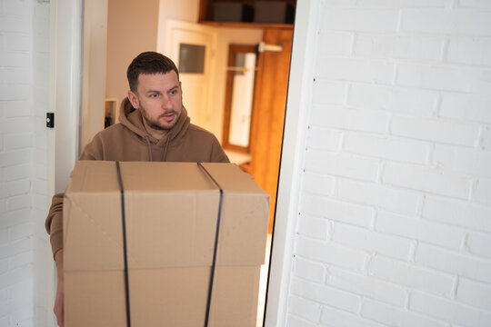 A man receives a package directly from a postal courier, showcasing timely order fulfillment and reliable delivery systems. 