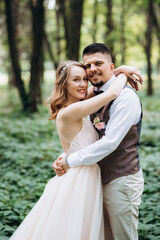 Fototapeta premium the bride and groom are walking in the park along the paths