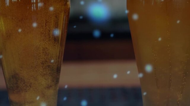 Camera pulling back revealing two tall beer glasses bubbles rising foam forming to show details
