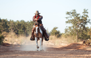 A cowboy on a rearing horse holding a revolver, capturing a classic and dramatic