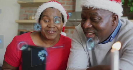 Mature woman holding phone, man leaning in causing AR graphics while showing gifts, sharing hello - Powered by Adobe