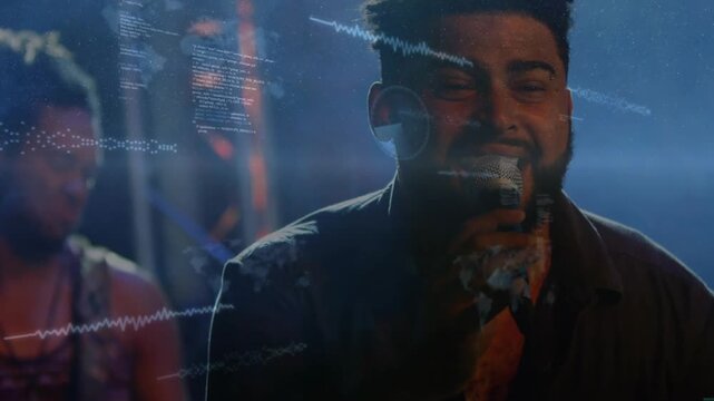 Lead singer starting vocal into mic in music-set, guitarist backing overlays forming waveform map