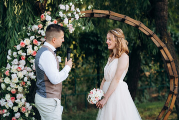 wedding ceremony of a young couple in love on a green meadow
