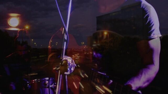 Woman raising cam, drums emerging amid highway streaks, male singer singing into mic for music
