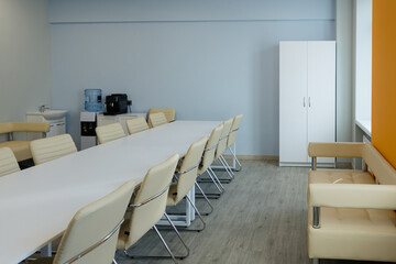 Modern conference room features a long table and comfortable seating for collaborative meetings