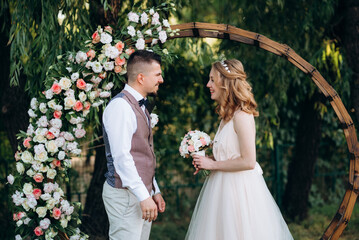 wedding ceremony of a young couple in love on a green meadow