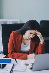 tired business woman sleepy and bored from sitting at a desk for a long time and has office syndrome