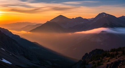 Golden hour paints the cascade mountains with warm hues and ethereal fog