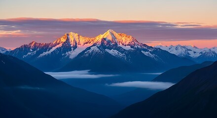 Mountaintop sunrise illuminates snowcapped peaks in a breathtaking landscape