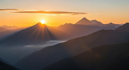 Sunburst over the mountain range at sunset with golden light shining through