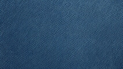 Close-up of denim fabric texture, showing diagonal weave pattern and blue color.