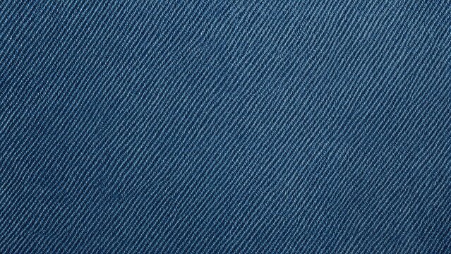 Close-up of denim fabric texture, showing diagonal weave pattern and blue color.