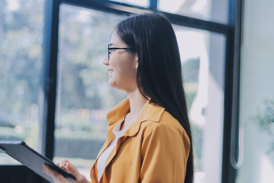 Business woman using calculator for do math finance on wooden desk in office and business working background, tax, accounting, statistics and analytic research concept. - Powered by Adobe