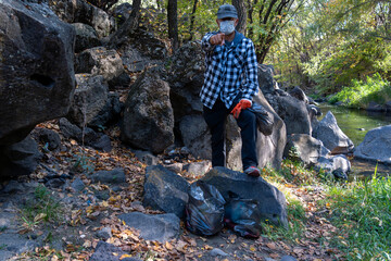 Eco Activist Man in Nature with Garbage Bags – Environmental Message Concept