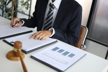 Legal counsel reading contract paperwork to finalize a legal agreement. Concepts for legal counsel, judicial authority, and the finality of a decision or agreement. 