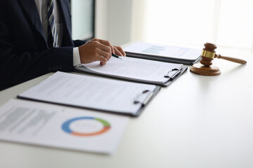 Legal counsel reading contract paperwork to finalize a legal agreement. Concepts for legal counsel, judicial authority, and the finality of a decision or agreement. 