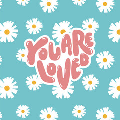 Soft and uplifting floral graphic with hand-lettered “You Are Loved” typography over a turquoise daisy pattern. A sweet, comforting statement perfect for girl’s casual kidswear and summer-themed print