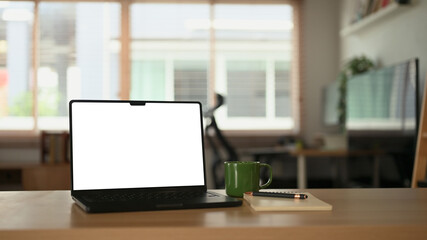 White office desk with computer laptop, plant and document at home office