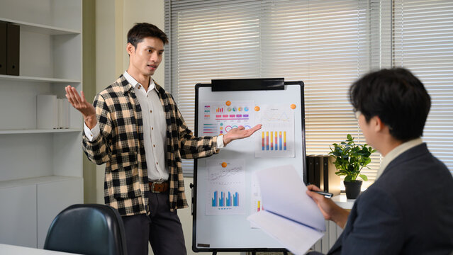 Pitching series photo, man presenting and pitching business ideas at boardroom - Powered by Adobe