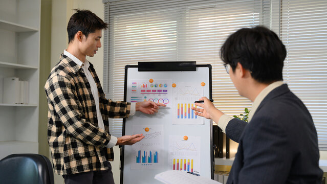 Pitching series photo, man presenting and pitching business ideas at boardroom - Powered by Adobe