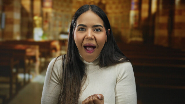 Woman smiling in a church setting, showcasing joyful and peaceful expressions with a vibrant energy indoors.
