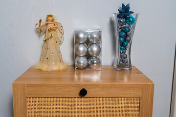 Christmas angel decoration with 2 different shaped vases with blue metallic baubles inside