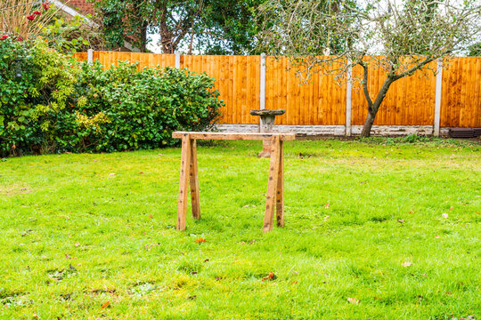 Wooden sawhorse in the garden, woodworking stand used by carpenters, construction workers and DIY enthusiasts