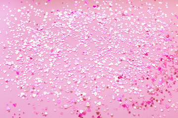 Abstract background of pink heart-shaped sparkles.