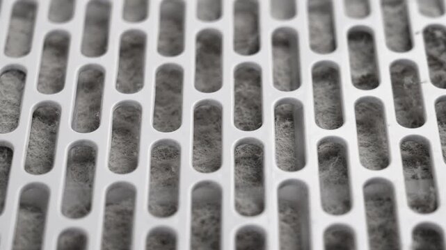 Dirty dusty filter grill of a home air purifier close up. Rotation. Maintenance service concept