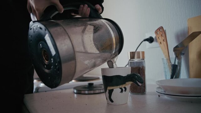 Disabled person with a limb difference preparing coffee at home