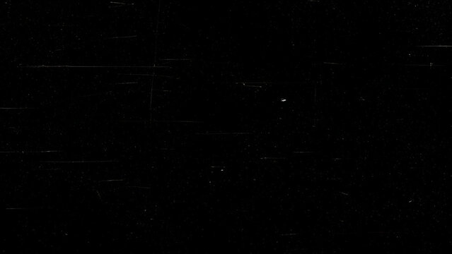 Black surface with horizontal scratches and dust specks