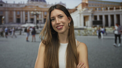 Fototapeta premium Young hispanic woman smiling warmly on sunny morning in front of sunlit building facade at vatican; joy.