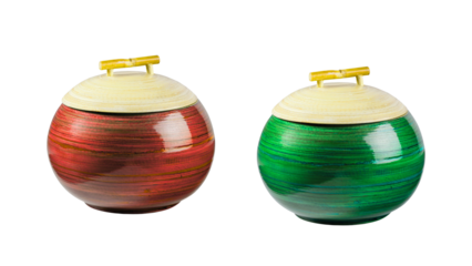 A pair of handcrafted red and green round bamboo canisters with lids, ideal for decorative kitchen or home storage, isolated on a transparent background