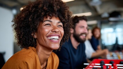 Woman smiling at camera in office setting with colleagues.