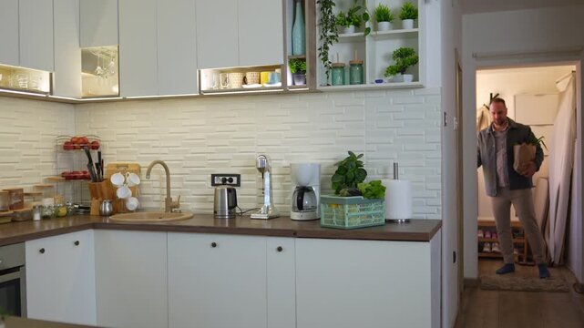 Handyman using an electric drill to install a kitchen cabinet door hinge