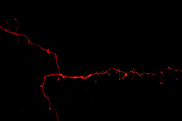 Red paint splash isolated on black background.