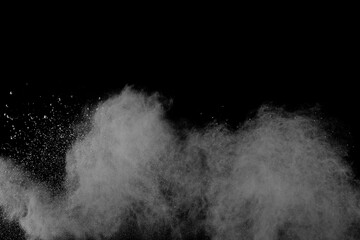 White powder explosion on black background. Colored cloud. Colorful dust explode. Paint Holi.