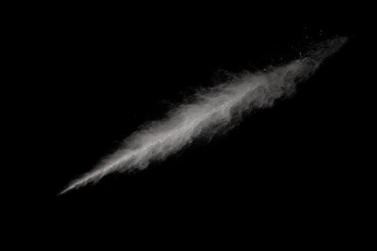 White powder explosion on black background. Colored cloud. Colorful dust explode. Paint Holi.