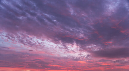 Beautiful bright sunset sky with colorful clouds. Sky background.