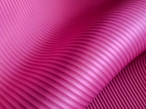A wavy surface featuring parallel ridges, creating a dynamic and flowing visual effect. 
