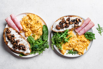 Healthy balanced breakfast with scrambled eggs, sandwich, ham
