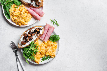 Healthy balanced breakfast with scrambled eggs, sandwich, ham