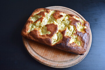 Cottage cheese pie on a wooden tray.