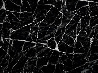 Close-up of black marble with white veining. The intricate pattern of cracks and lines creates a textured, abstract design.