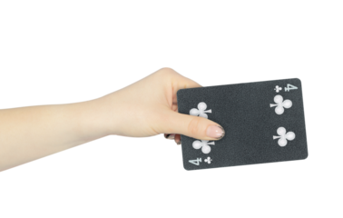 playing card clubs 4 in hand, outstretched hand with black playing card isolated from background