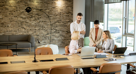 Business meeting in a modern office with diverse team members discussing strategies